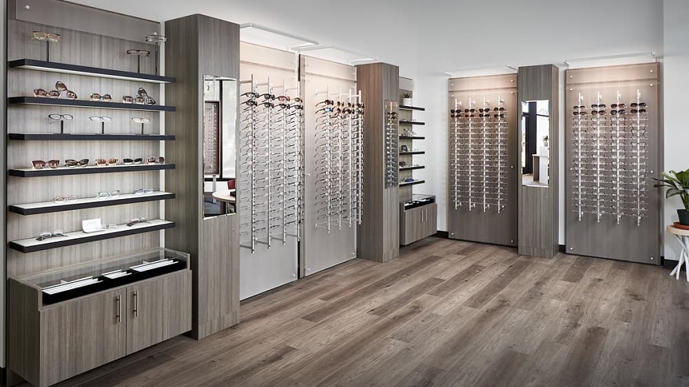 Modern eyeglass display showroom featuring organized rows of designer frames